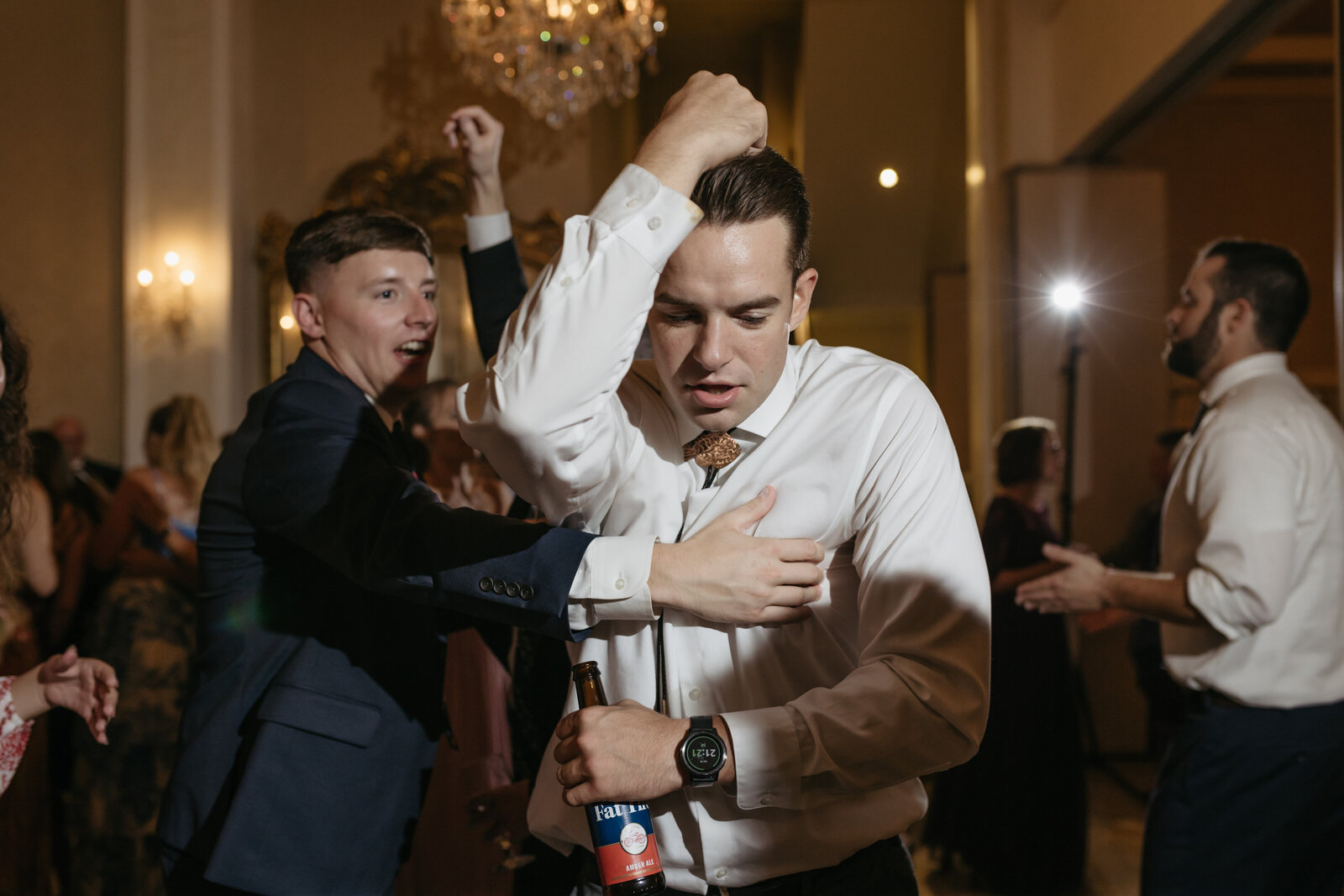 A man dances during a wedding reception in a hotel