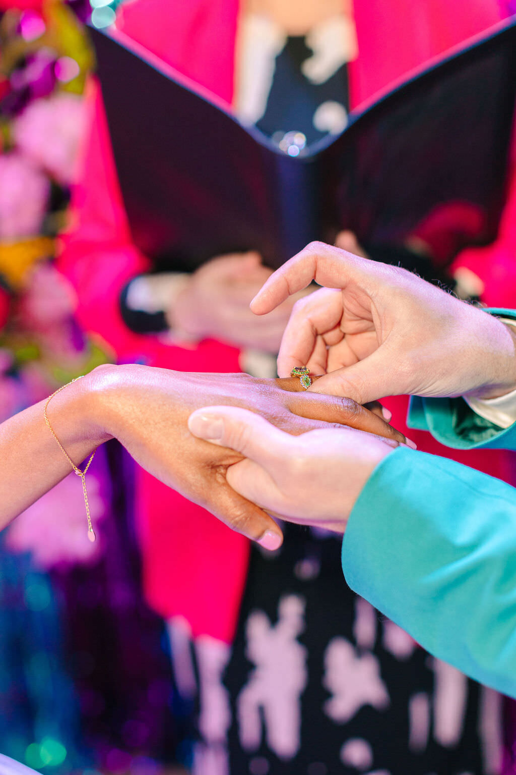 A person putting a ring on another person's finger.