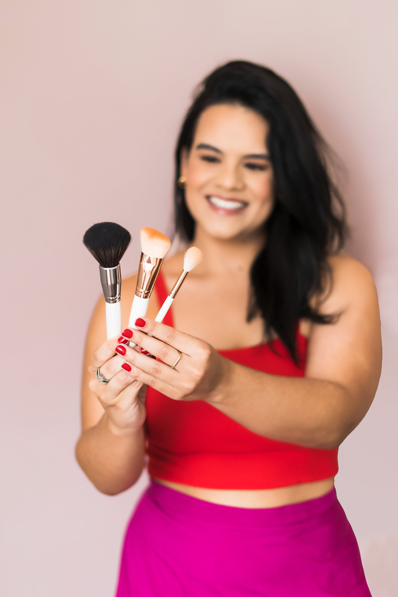 a blur make up artist holds a set of brushes in focus