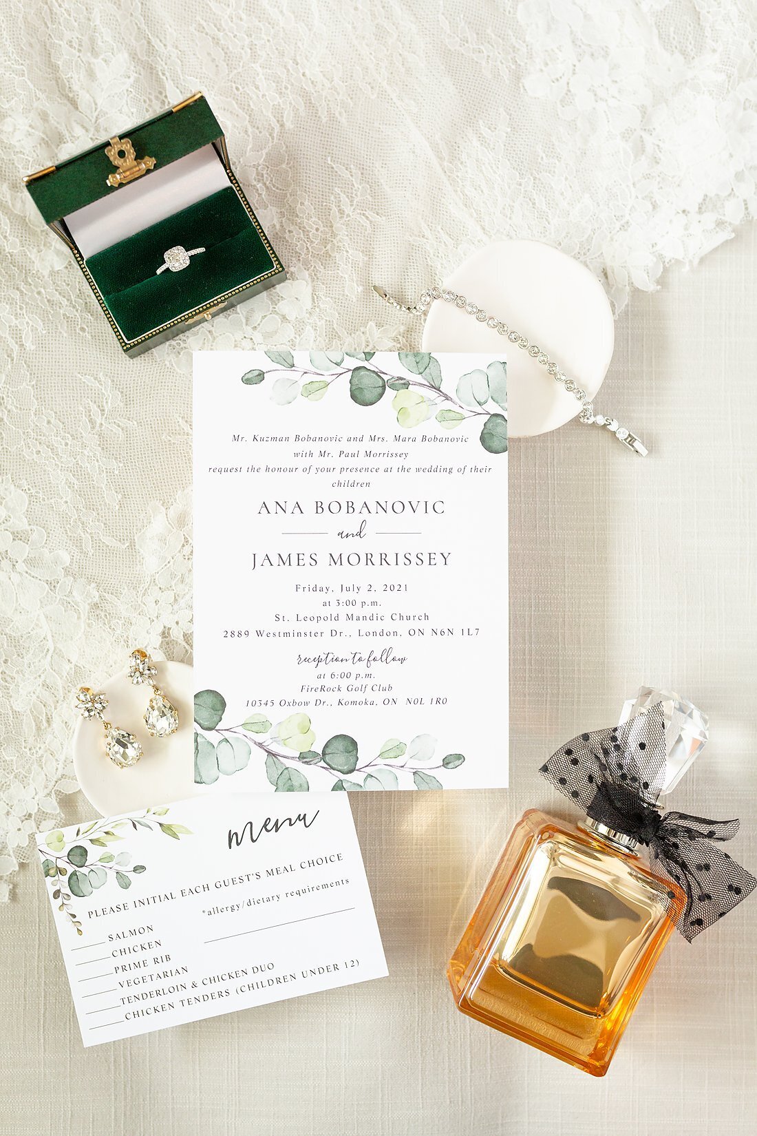 Bridal-wedding-details-and-invitation-on-top-of-the-wedding-dress