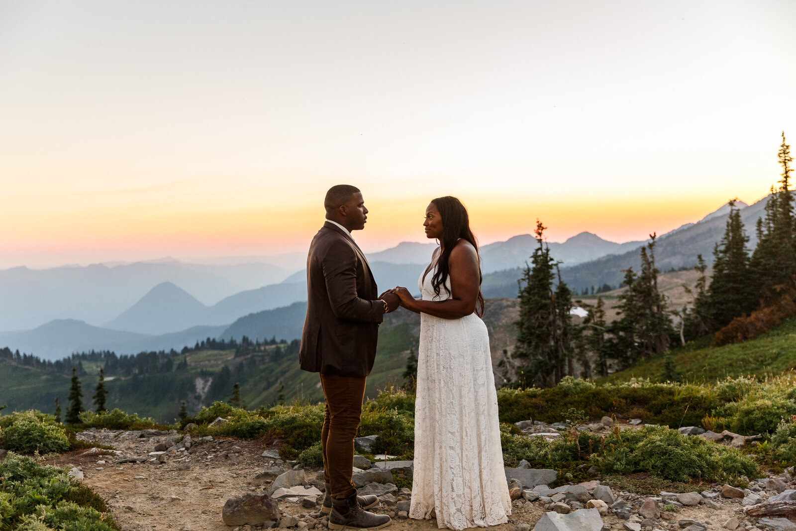 a couple sharing vows at their sunset washington elopement
