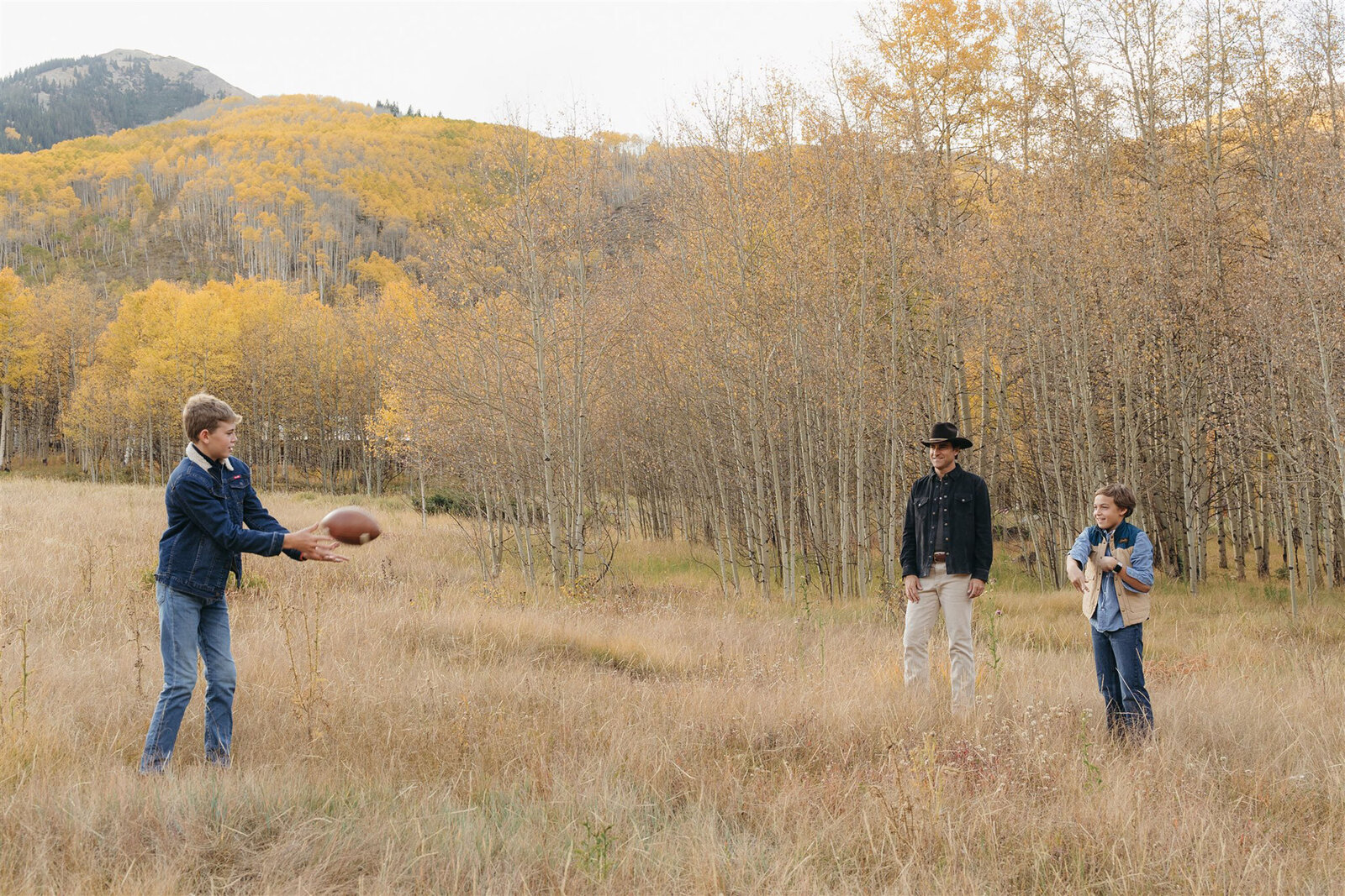Luxury Aspen family photography — the Stanley family styled in Ralph Lauren–inspired layers with the Rocky Mountains in the background.
