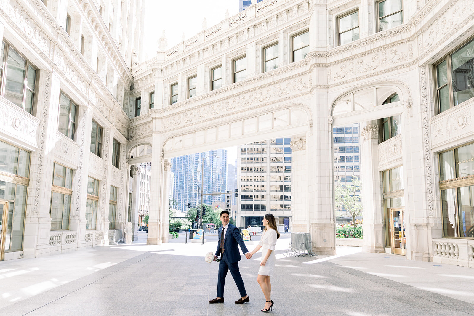 bride and groom walking by wrigley building