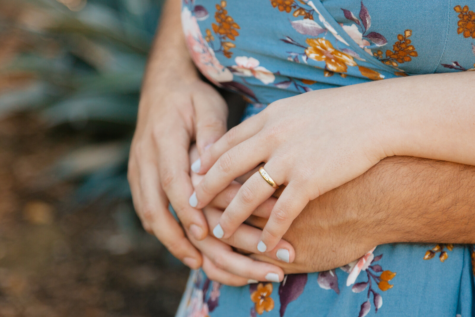 An engaged couple poses for photos in a garden in Los Angeles, Ca.