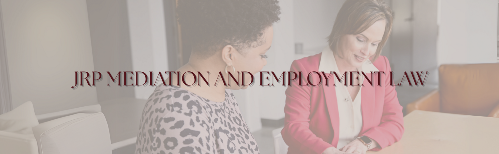 alt="Jennifer R Petersen in a pink blazer consulting with a client in a business meeting, JRP Mediation and Employment Law Firm"
