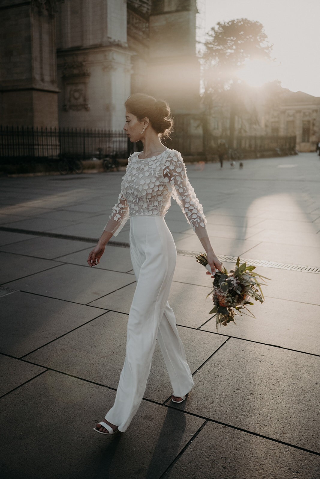 Beautiful bride in the sunset light walking in the streets of Bordeaux