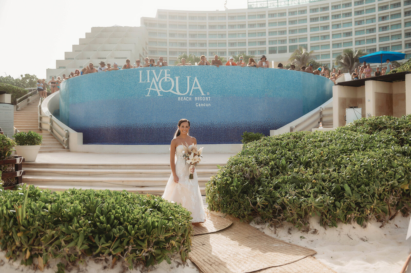 Bride walks down the isle at her Micro Wedding at Live Aqua Resort in Cancun Mexico.
