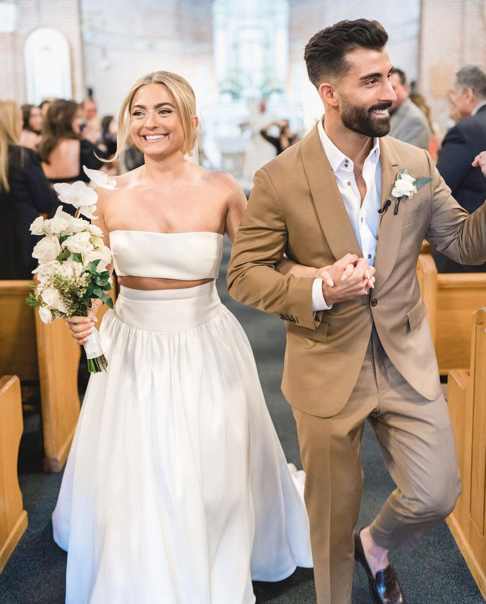 bride and groom smiling while walking after their wedding ceremony