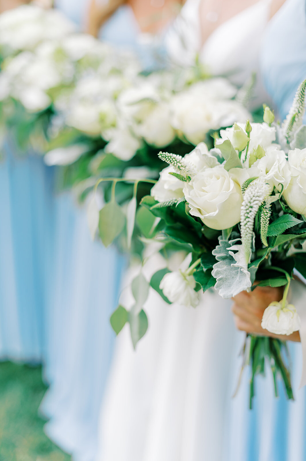 Blue bridesmaids dresses and white bouquets at Boise wedding venue, Honalee Farms, Captured by the Best Boise Wedding Photographers