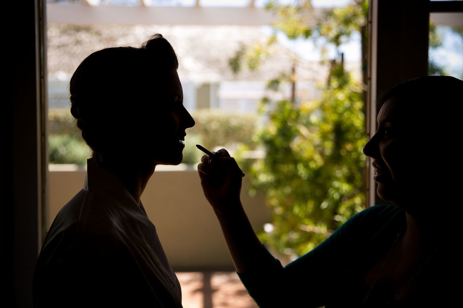 Creative silhouette of bride during makeup at Lauberge