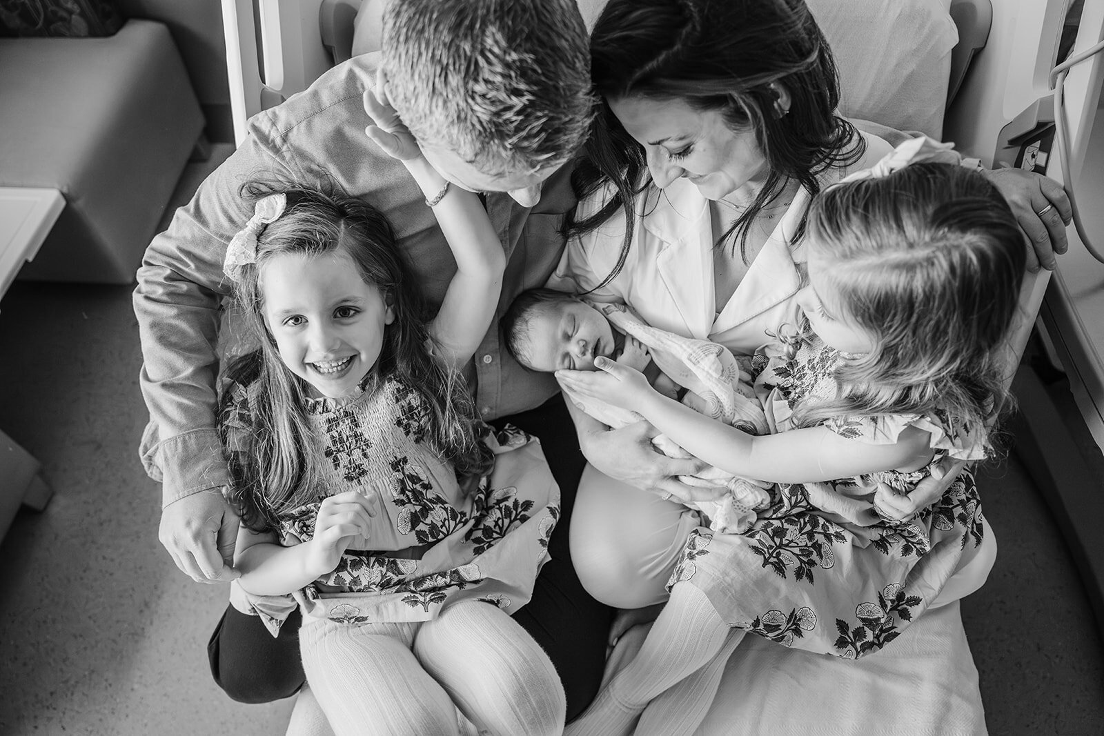 overhead shot of a family of five. in the hospital with new baby