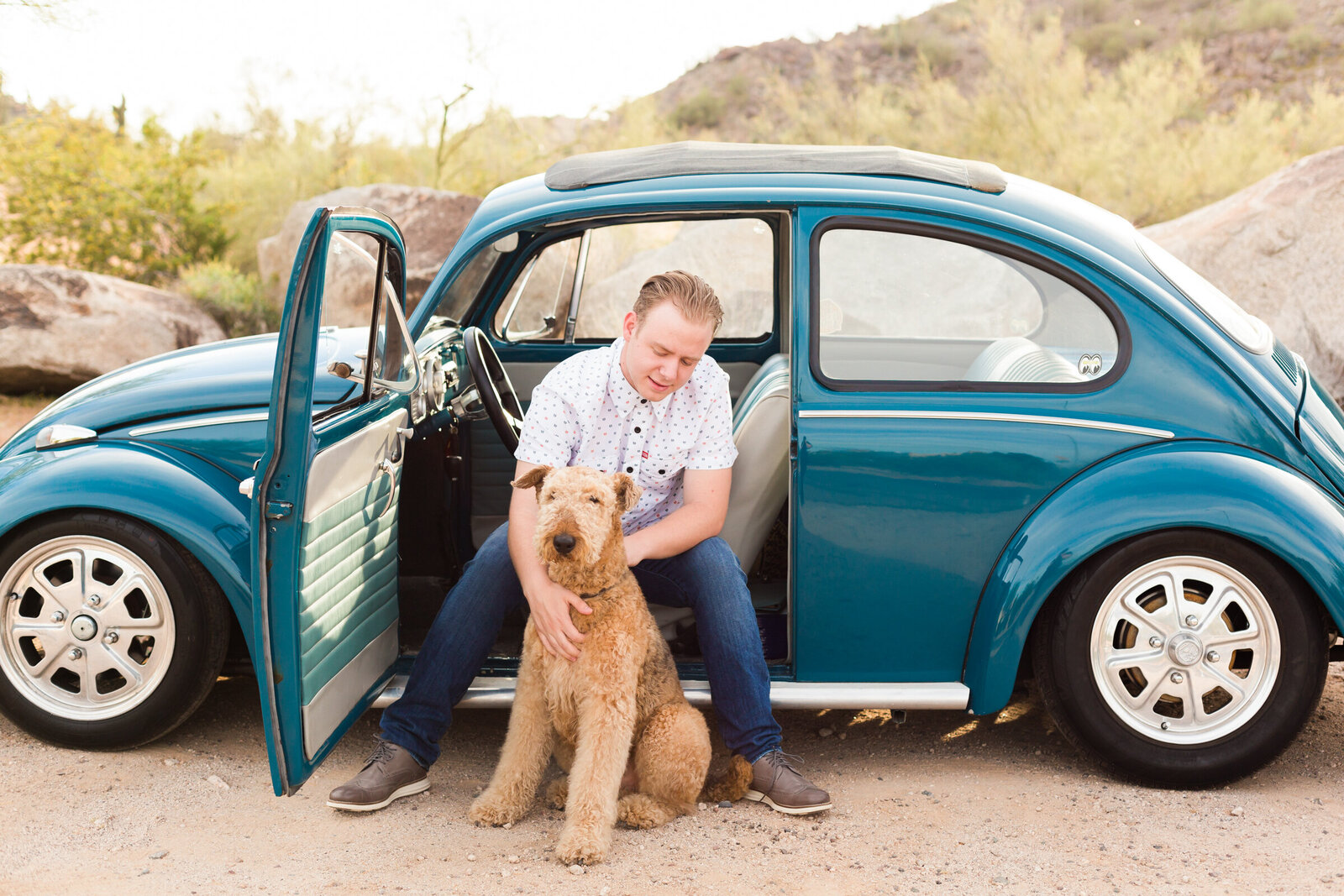 high school senior boy posing with VW bug and dog