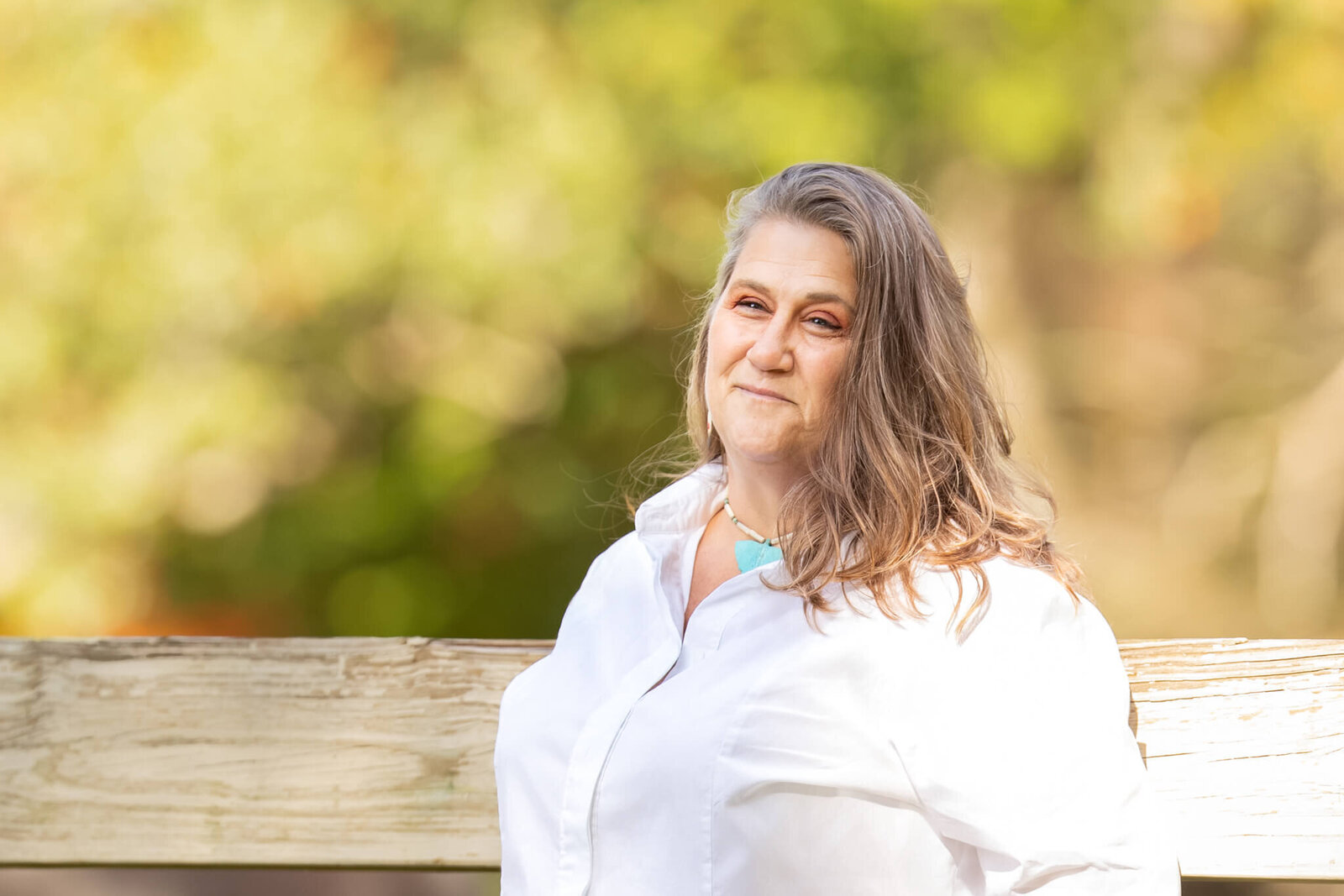 Portrait photo of adult female wearing a white button down top