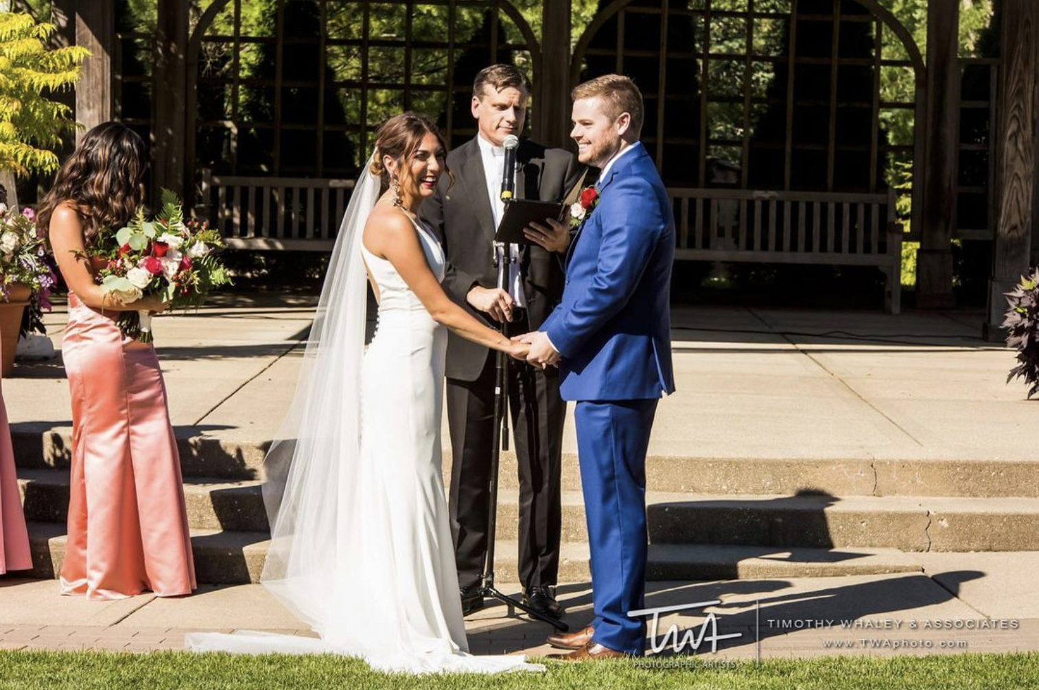 Bride smiles at her wedding guests while taking vows