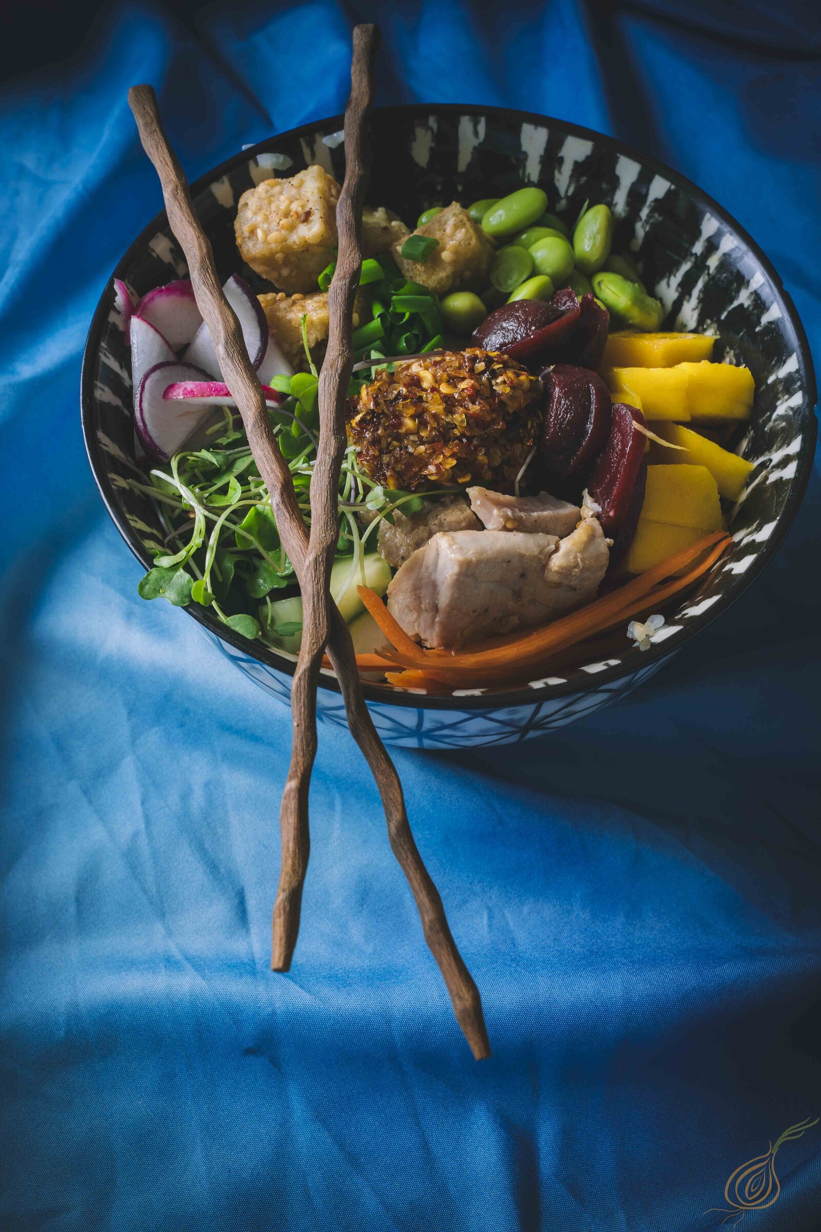 A bowl of food topped with chopsticks, elegantly arranged for a delightful dining experience.