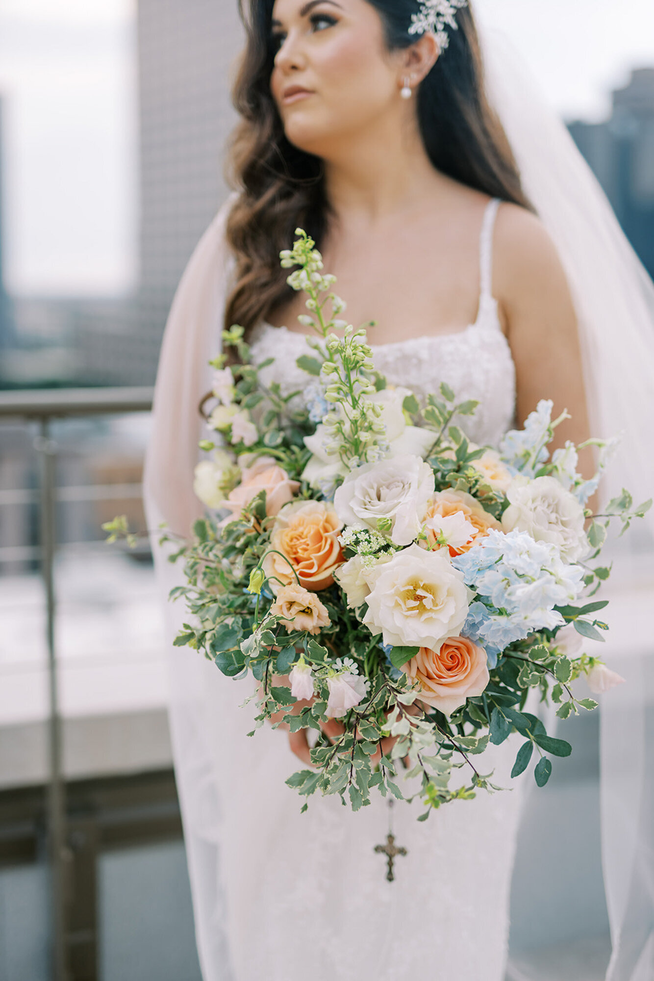 Jenna, a bride, holding colorful florals