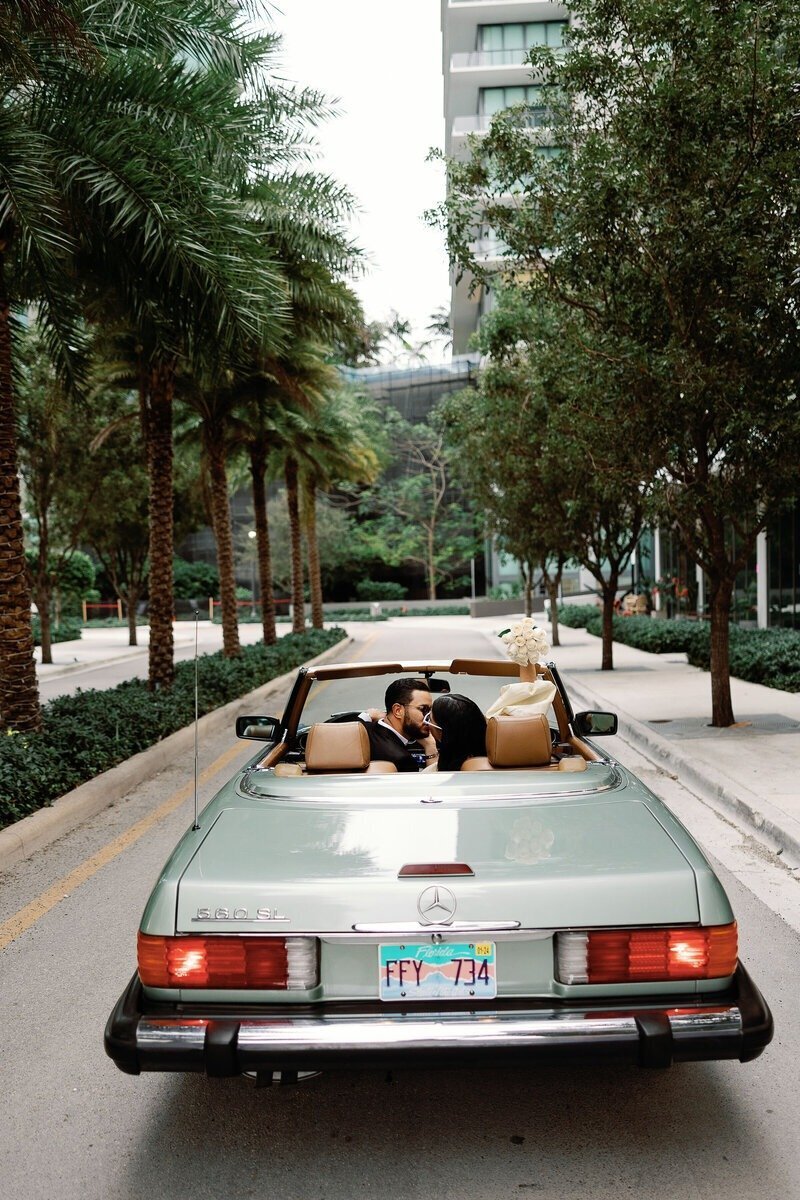 couple kissing in a car taken by engagement photographer naples fl