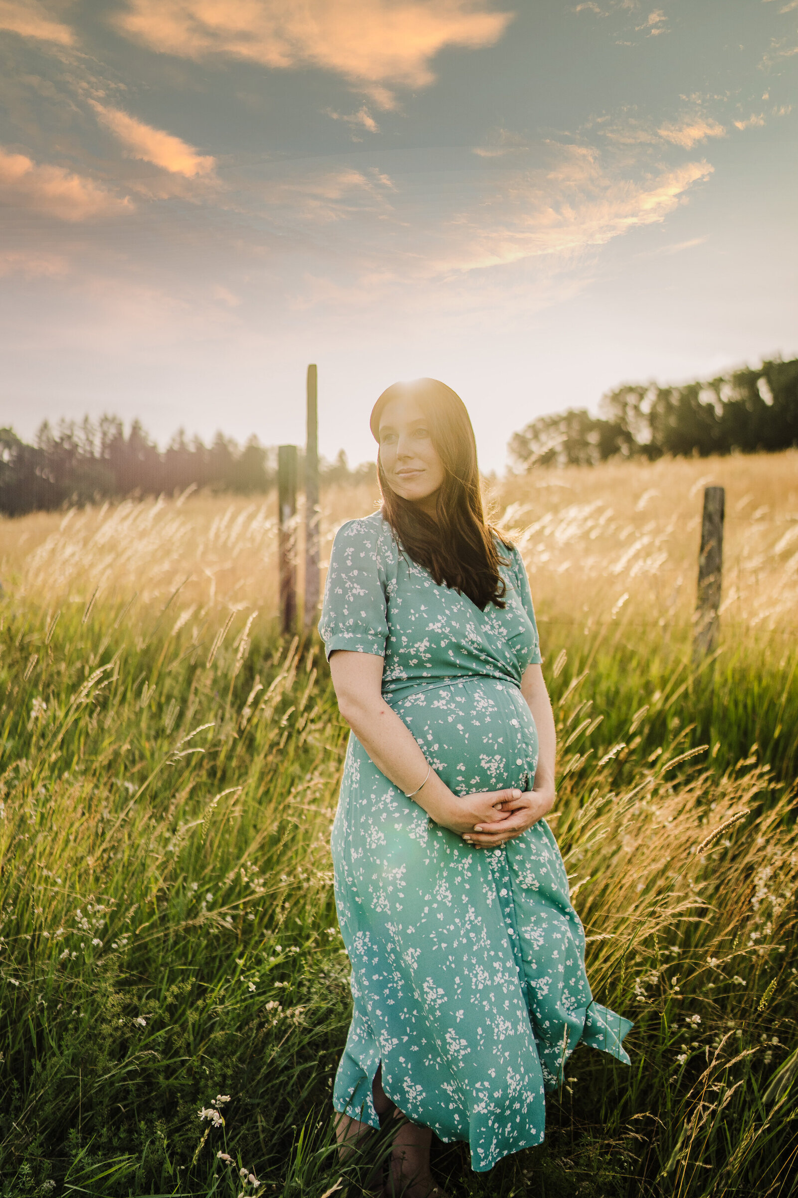 pregnant woman in field with wind blowing