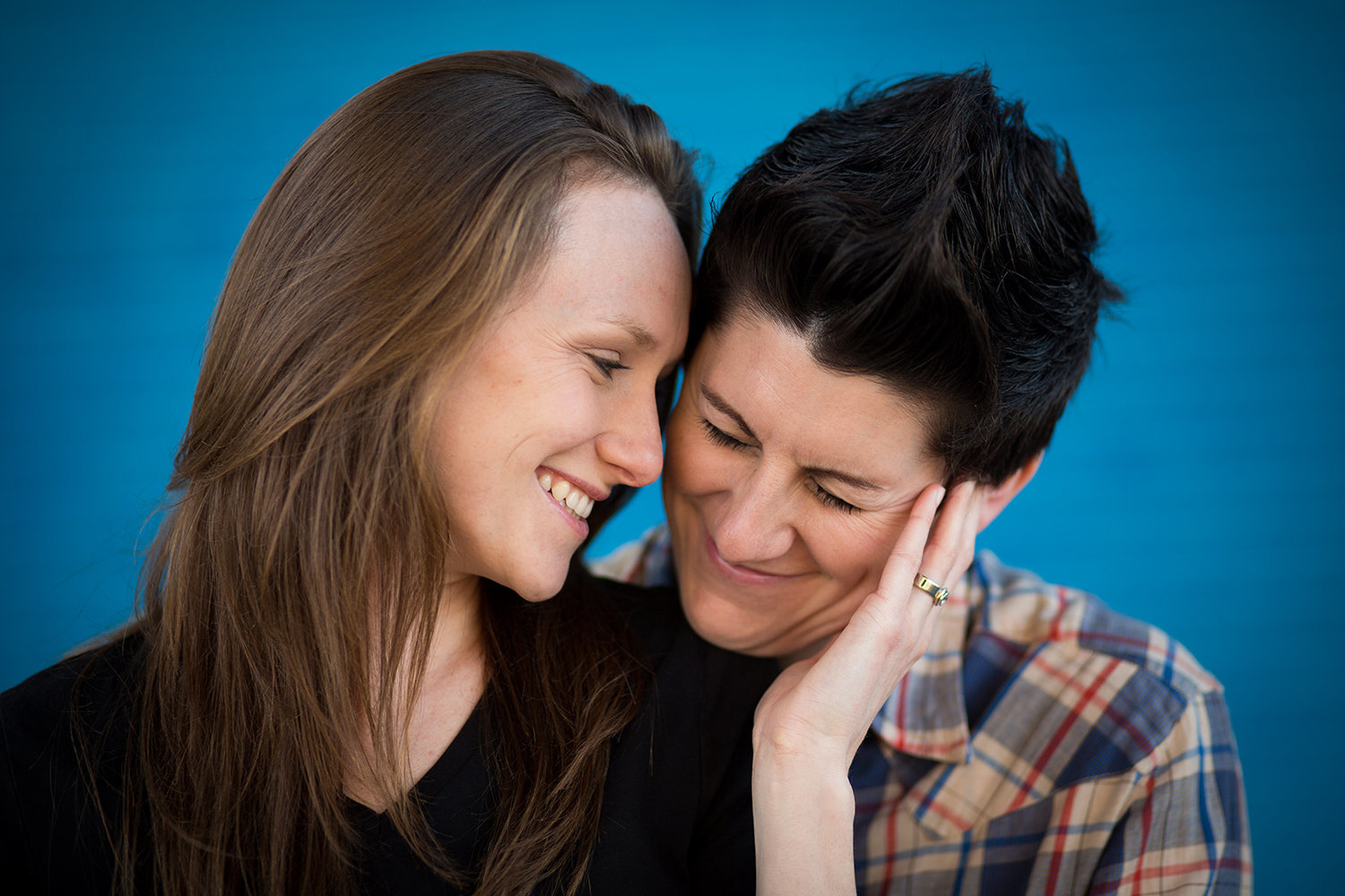 Sweet natural moment between the brides-to-be