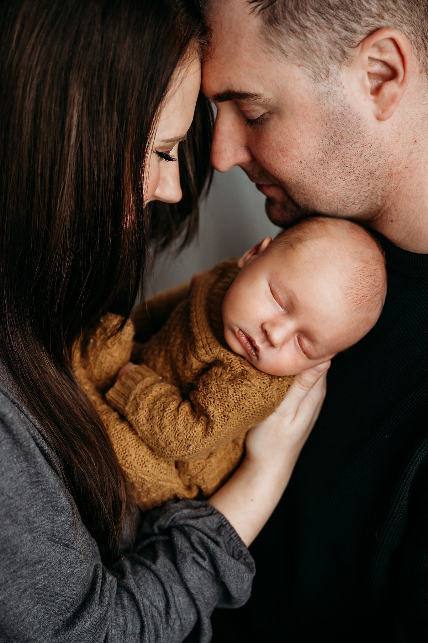 Mom, Dad, and baby snuggling