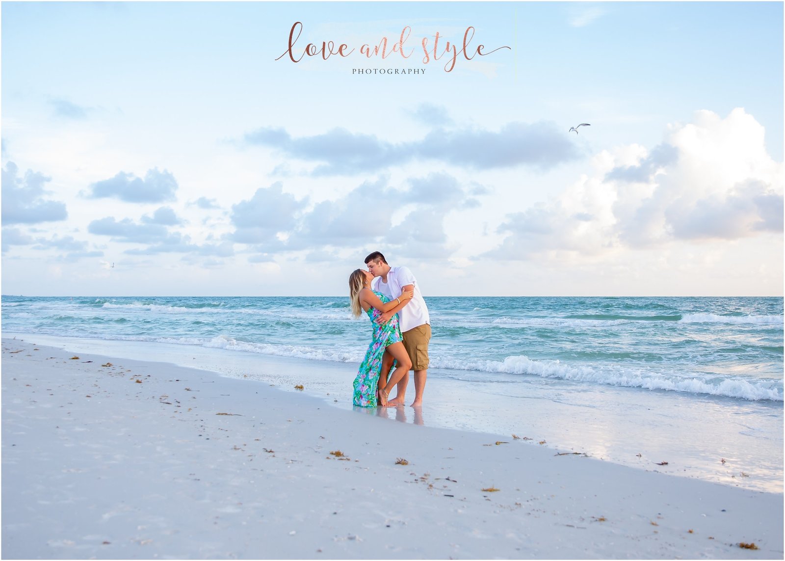 Engagement Photography at Bradenton Beach during sunset with couple kissing during sunset