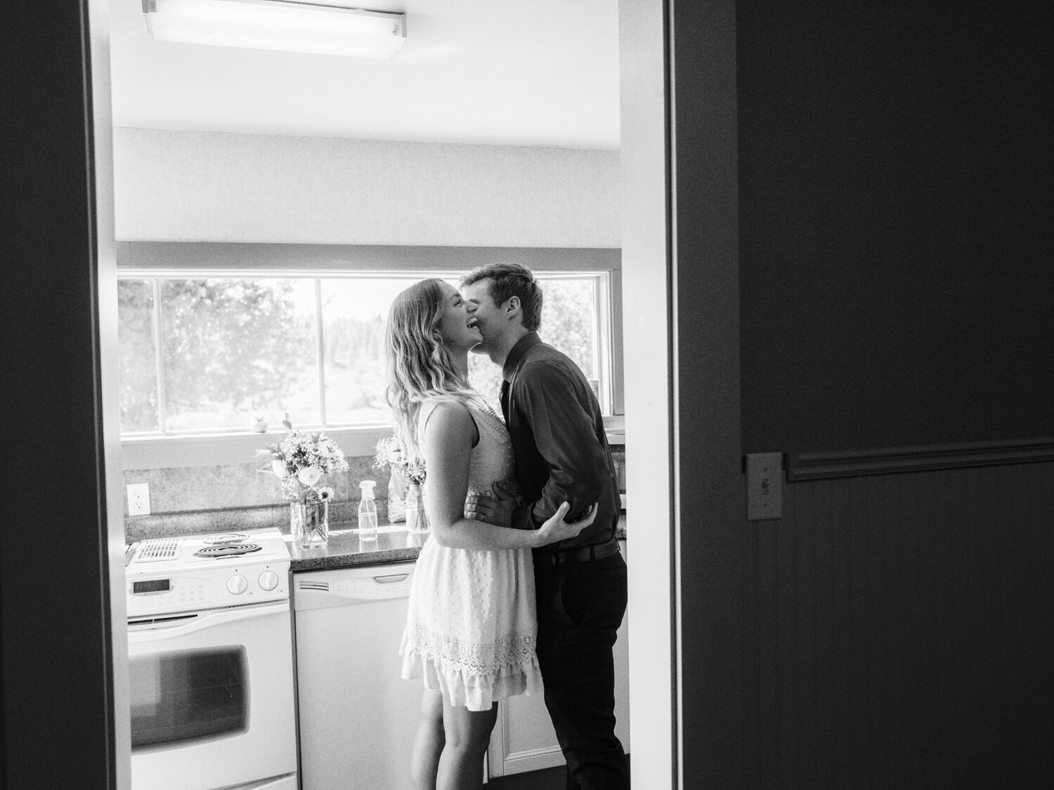 Bridesmaid and groomsmen kiss.