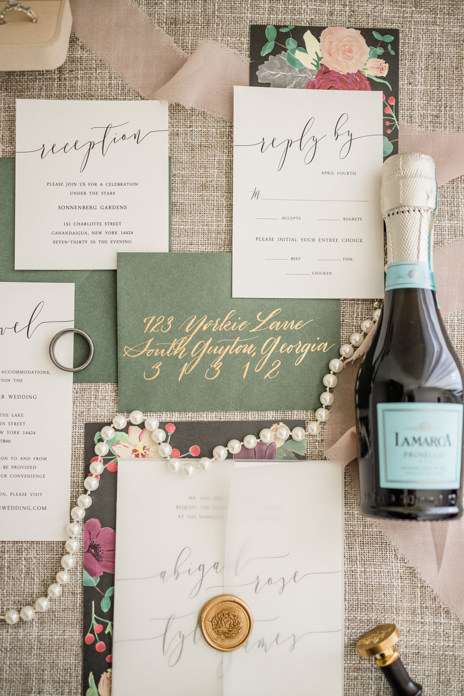 flatlay of wedding invitations and champagne