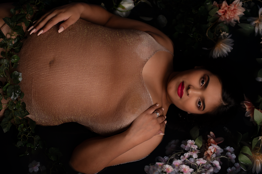 Los Angeles Maternity Photographer - Expecting Mom laying in water with a bed of flowers