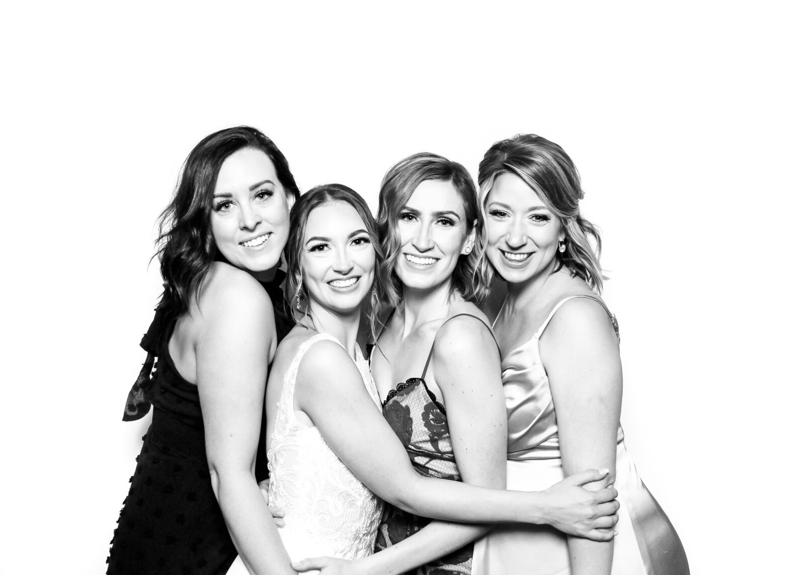 black and white portrait of 4 women hugging in a glam photo booth rental at a philadelphia event