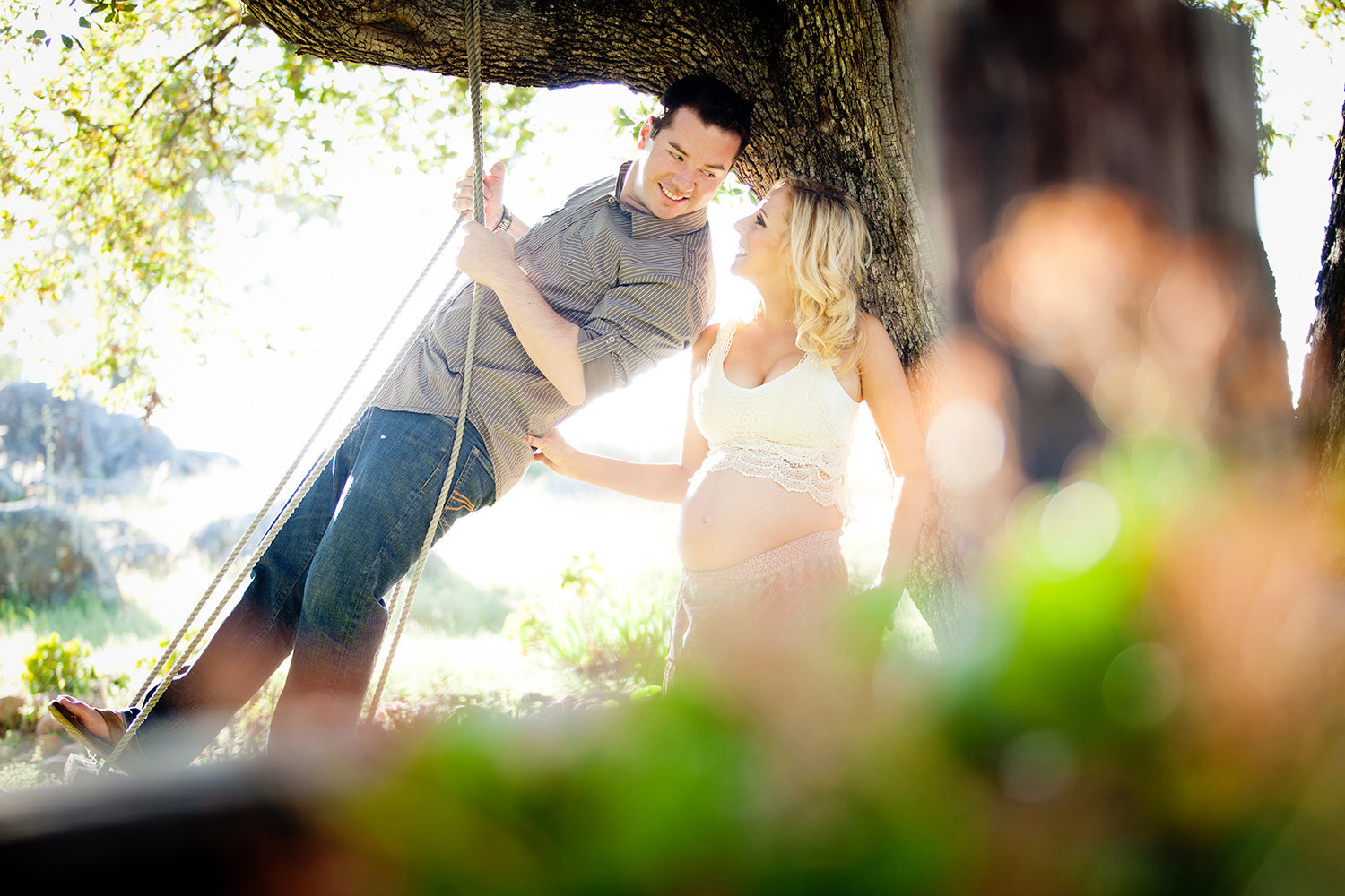Fun couple on a swing during the Maternity Session in San Diego.