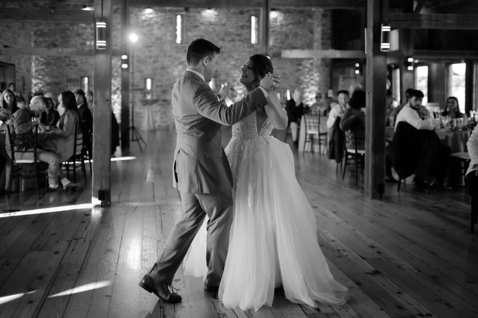 couple slow dancing wedding first dance in barn