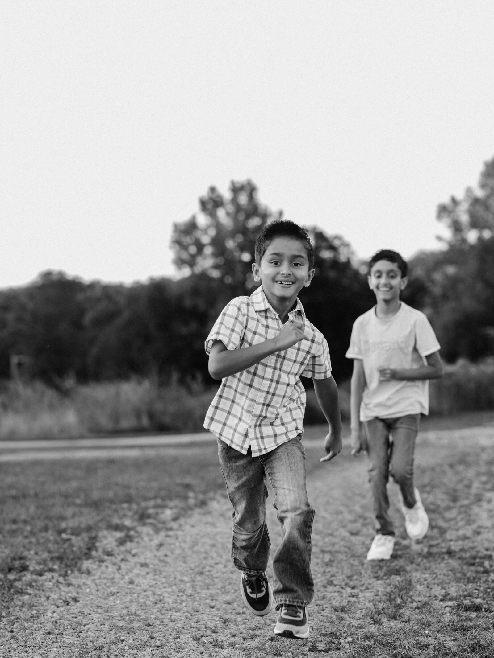 two brothers running in park for family photos cleveland family photography