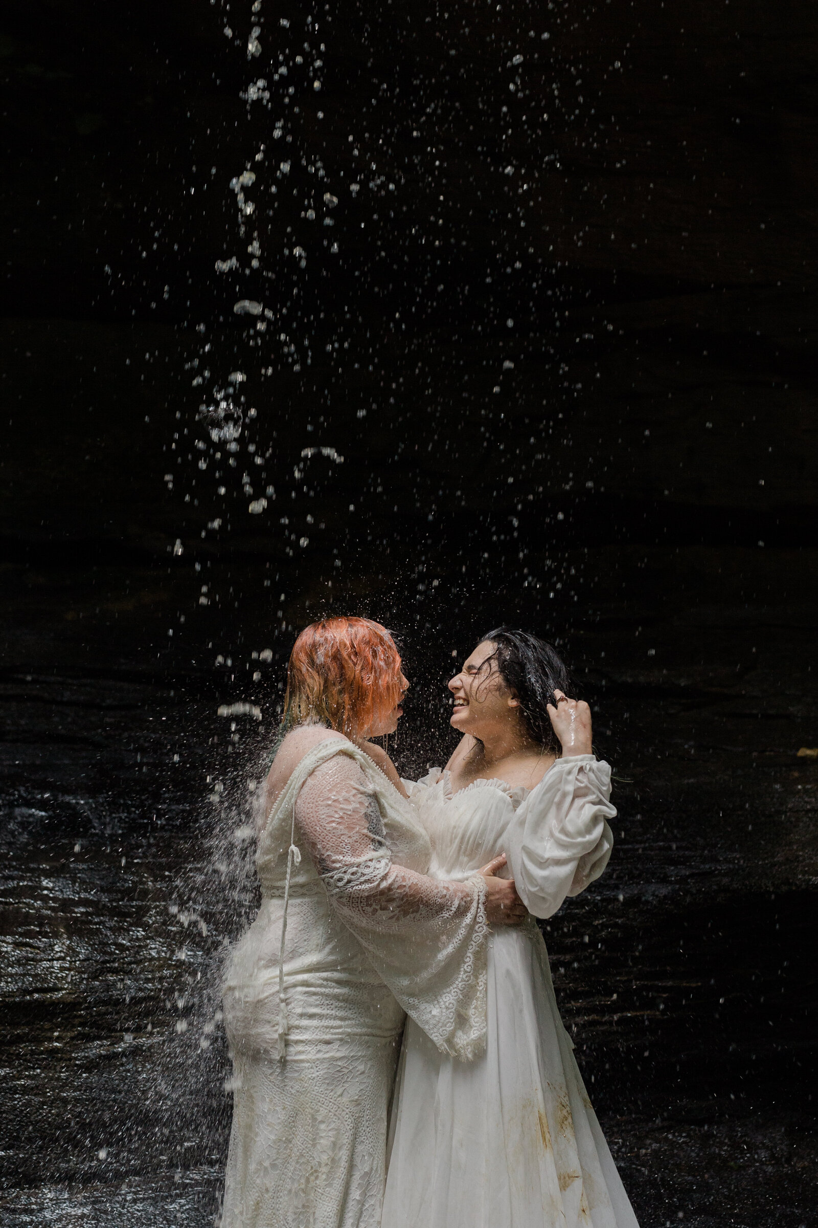 Same sex LGBT couple jump into waterfall after their vow ceremony