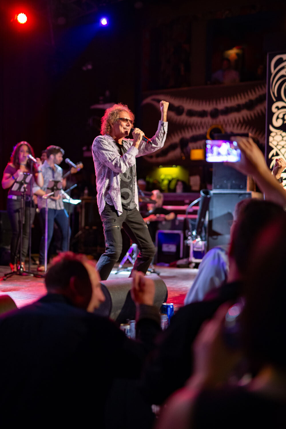 Singer performing on stage at a night corporate event