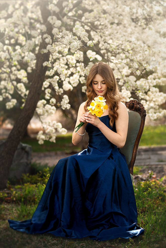 senior-high-school-girl-prom-dress-navy-elegant-daffodils-vintage-chair-outdoor-farm-white-blossoms