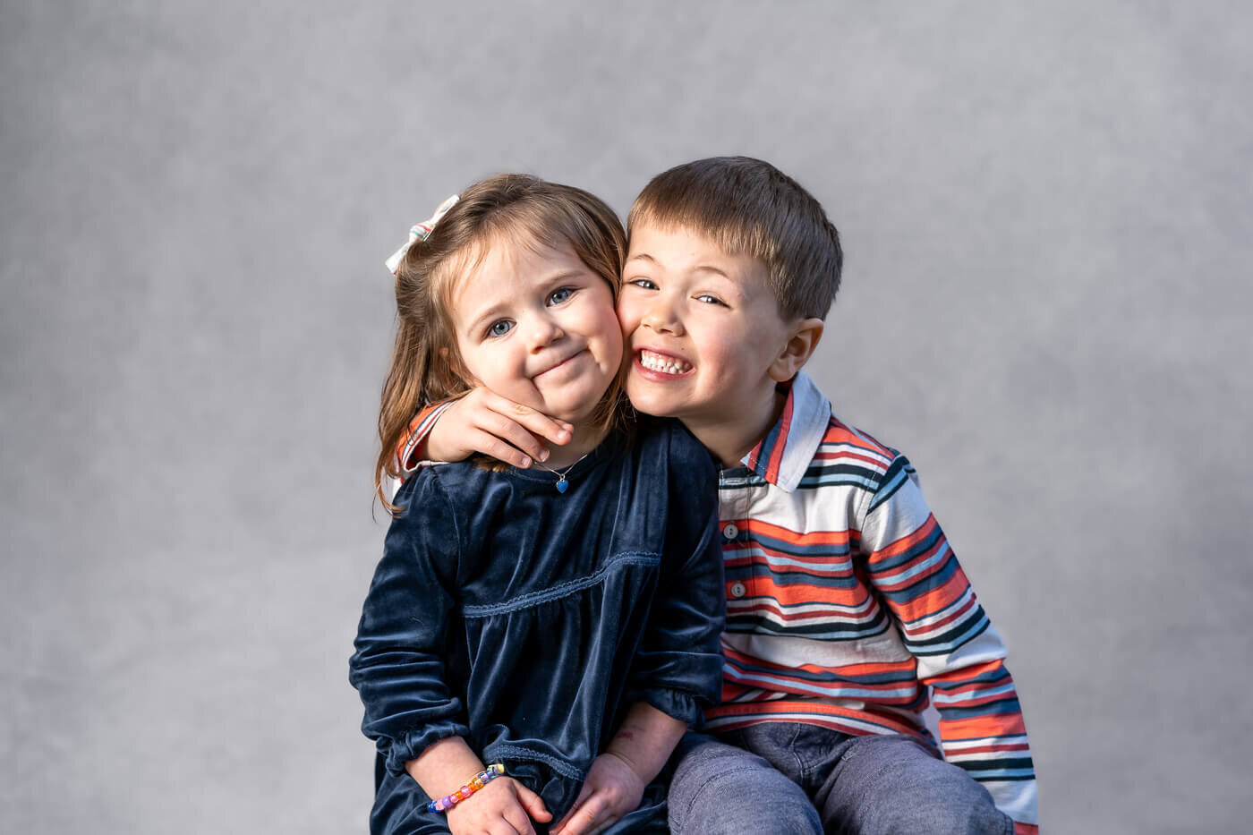 Two kids hug one another.