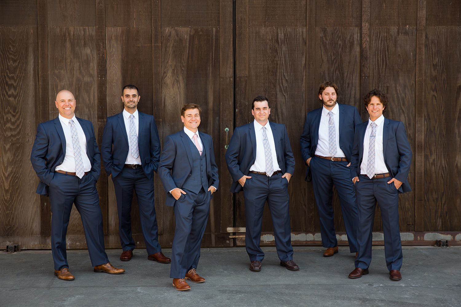 groom and groomsmen with wood walk