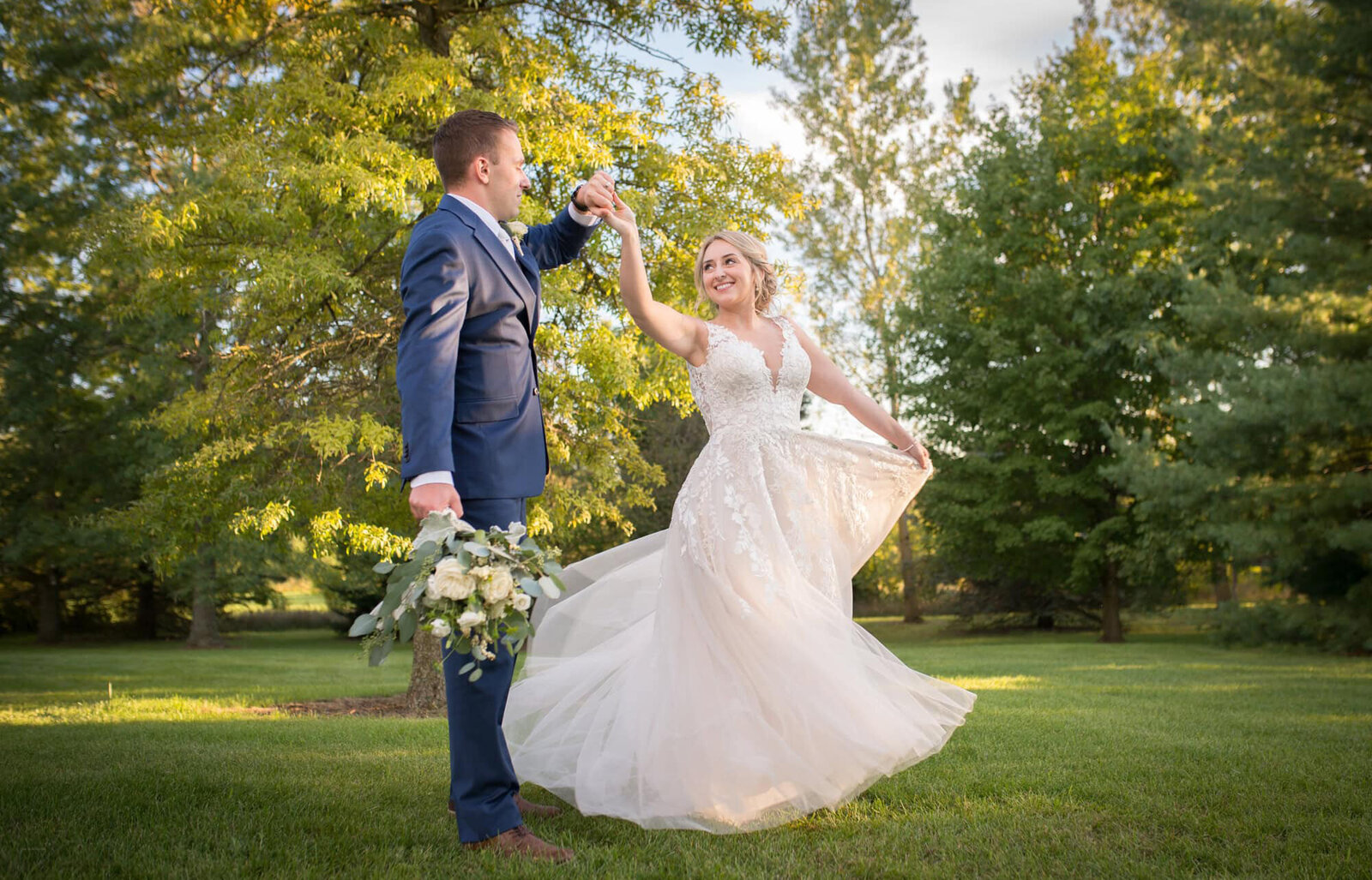 groom twirls bride in backyard