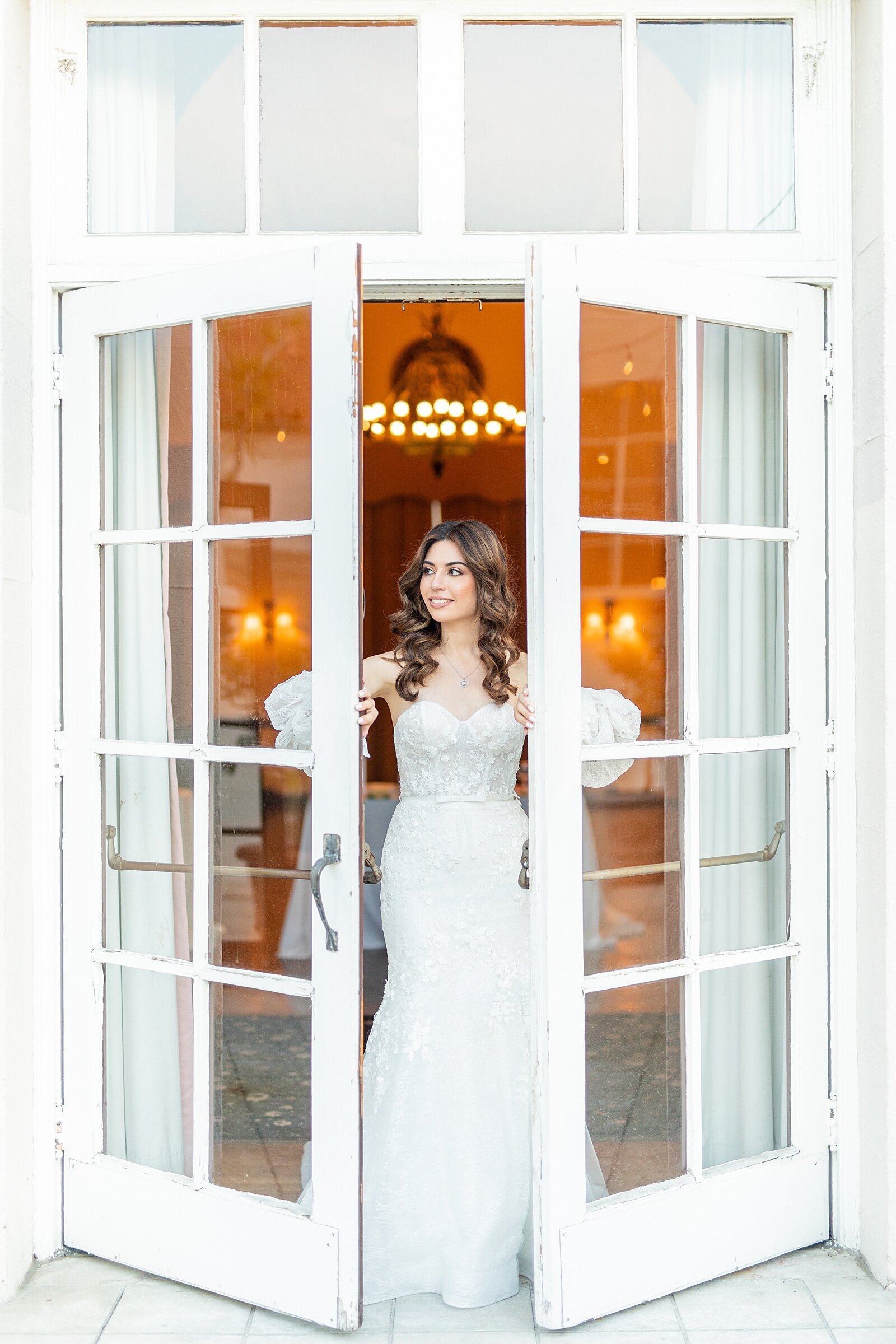 Bride walking out of glass double doors at The Ebell of LA.