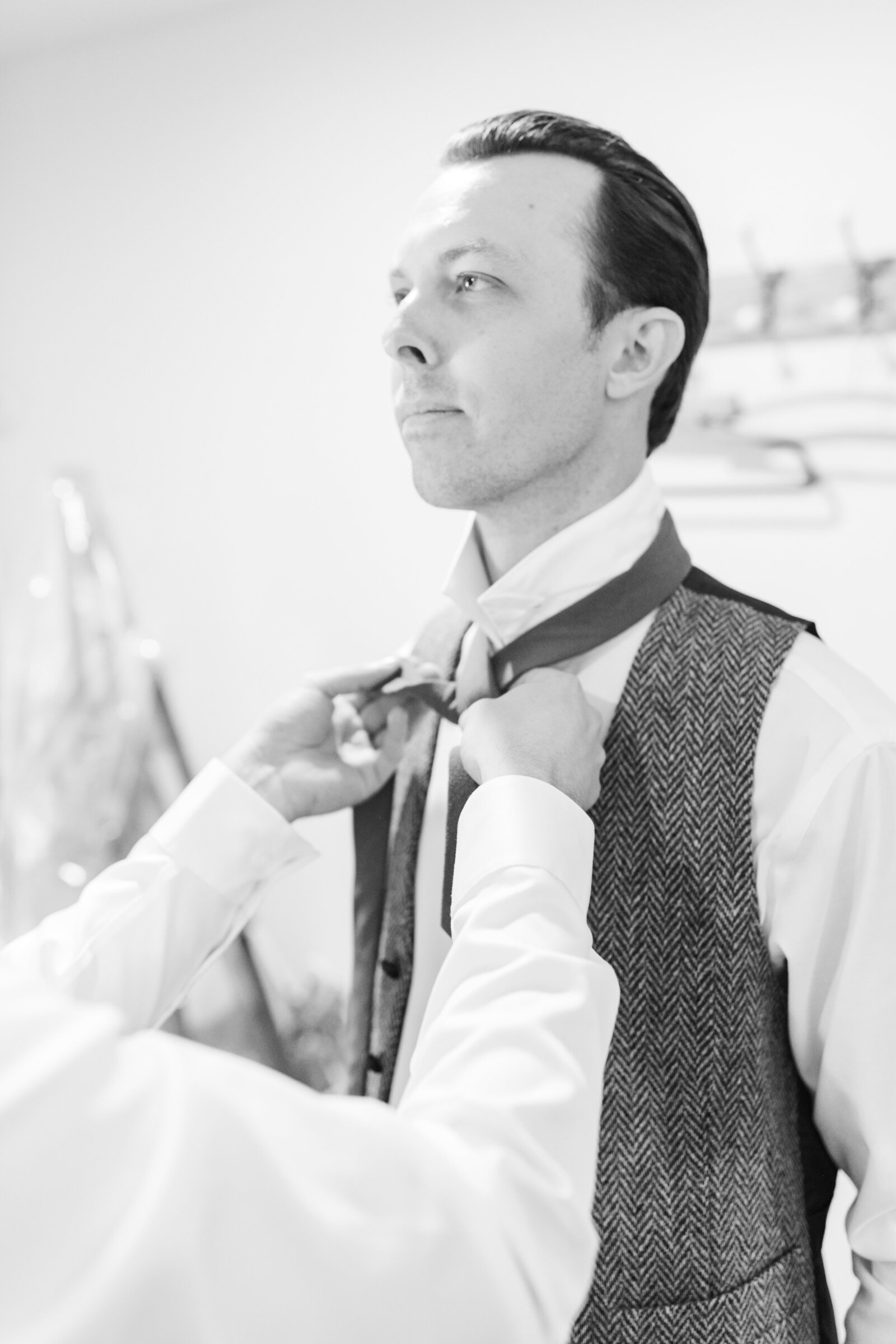 Groom getting ready on his colorful wedding day in Santa Cruz, California in the redwood trees.