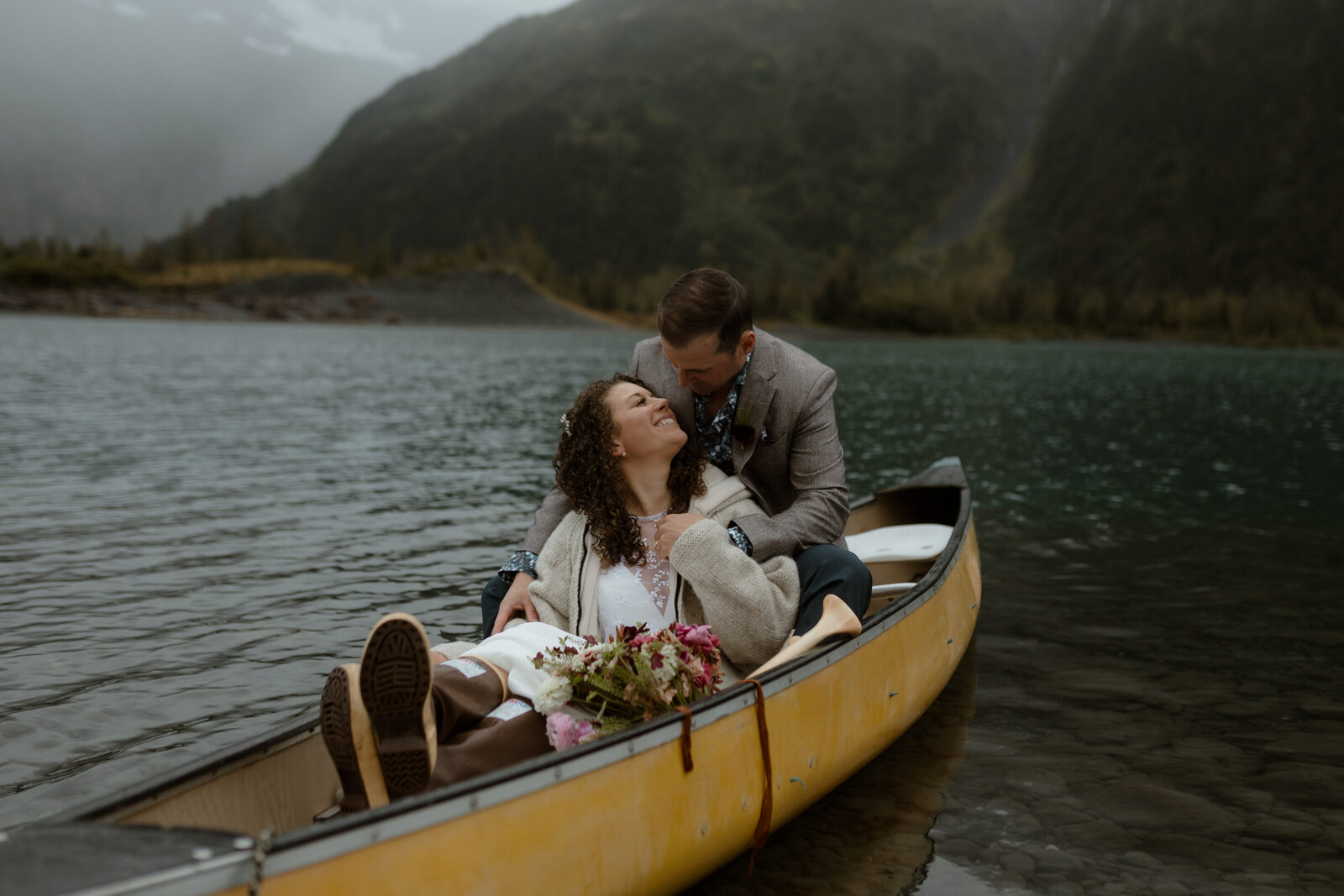 couple snuggling in canoe