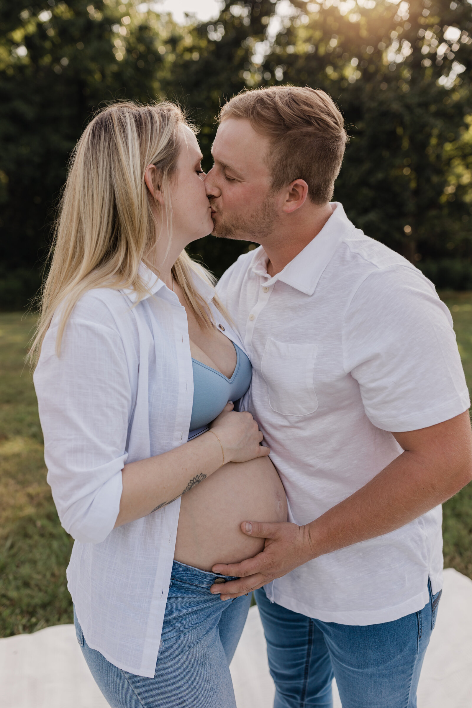 mother and father holding pregnant belly for maternity photoshoot