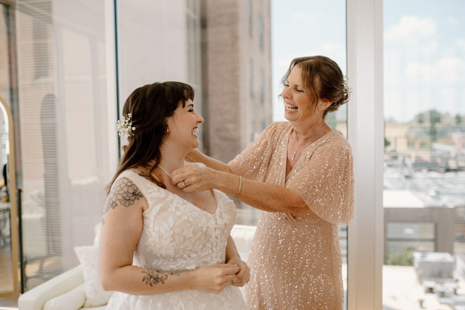 Bride smiling facing her smiling mom