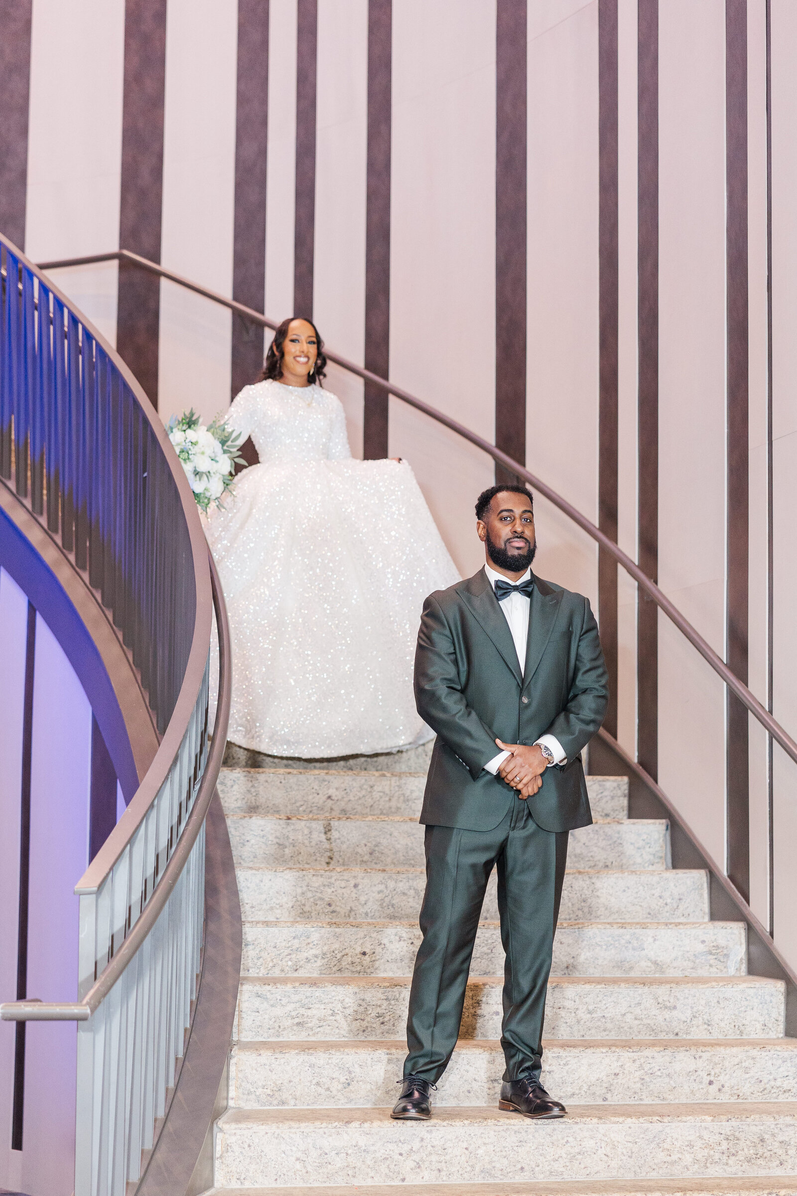 Bride walking down the stairs for first look 