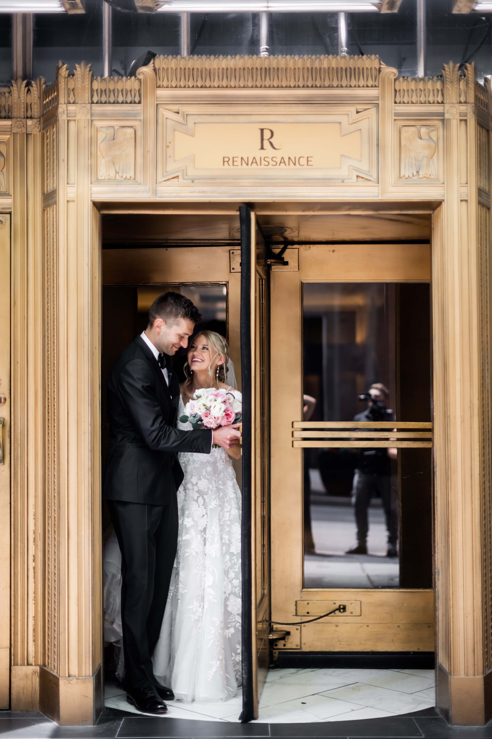 Capture the iconic moment as Hailey and Peter step out of the revolving doors of The Renaissance Hotel, marking the beginning of their new life together. This photograph celebrates the joy and elegance of their wedding day exit, framed by the grandeur of the hotel's architecture. Perfect for couples looking for memorable exit photo inspiration, this image exemplifies a blend of modern elegance and timeless romance.