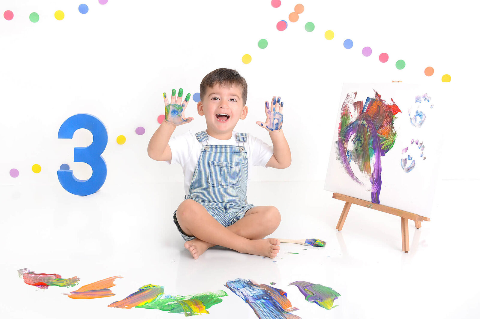 boy smiles at his 3rd birthday paint photoshoot