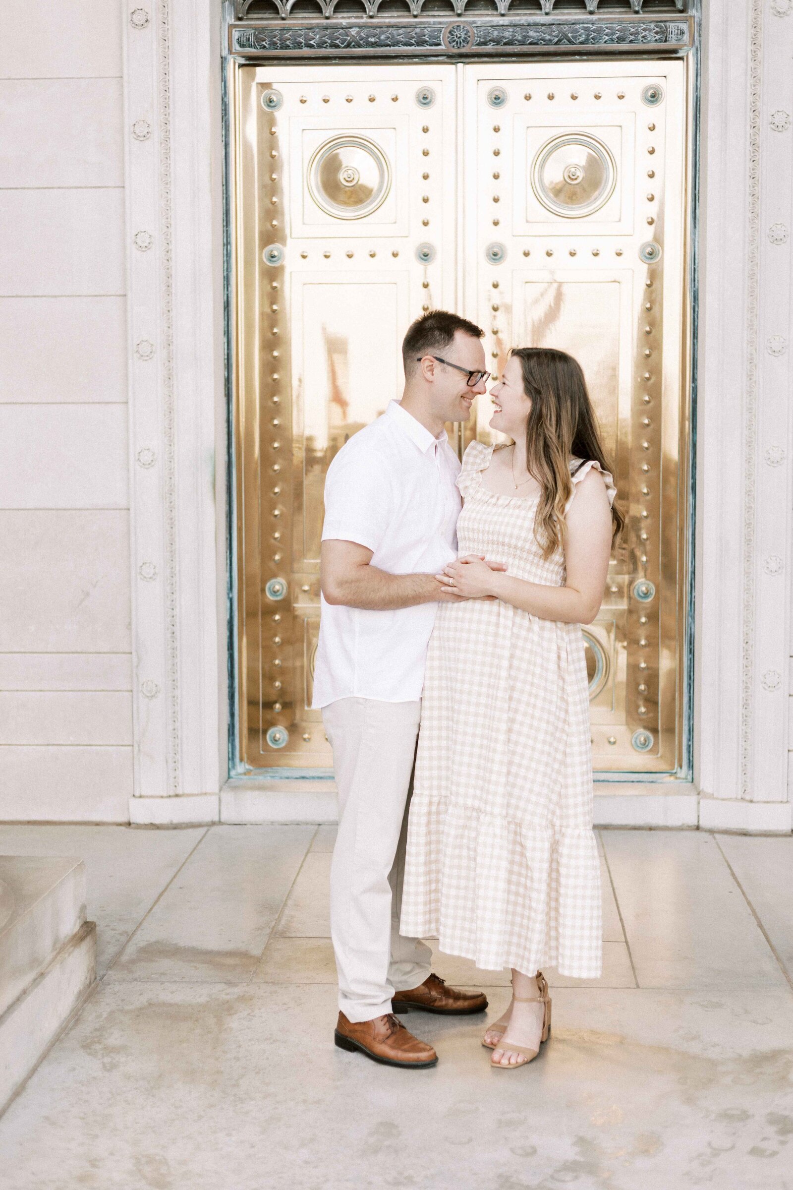 parents hugging and smiling during maternity photos in peoria illinois 