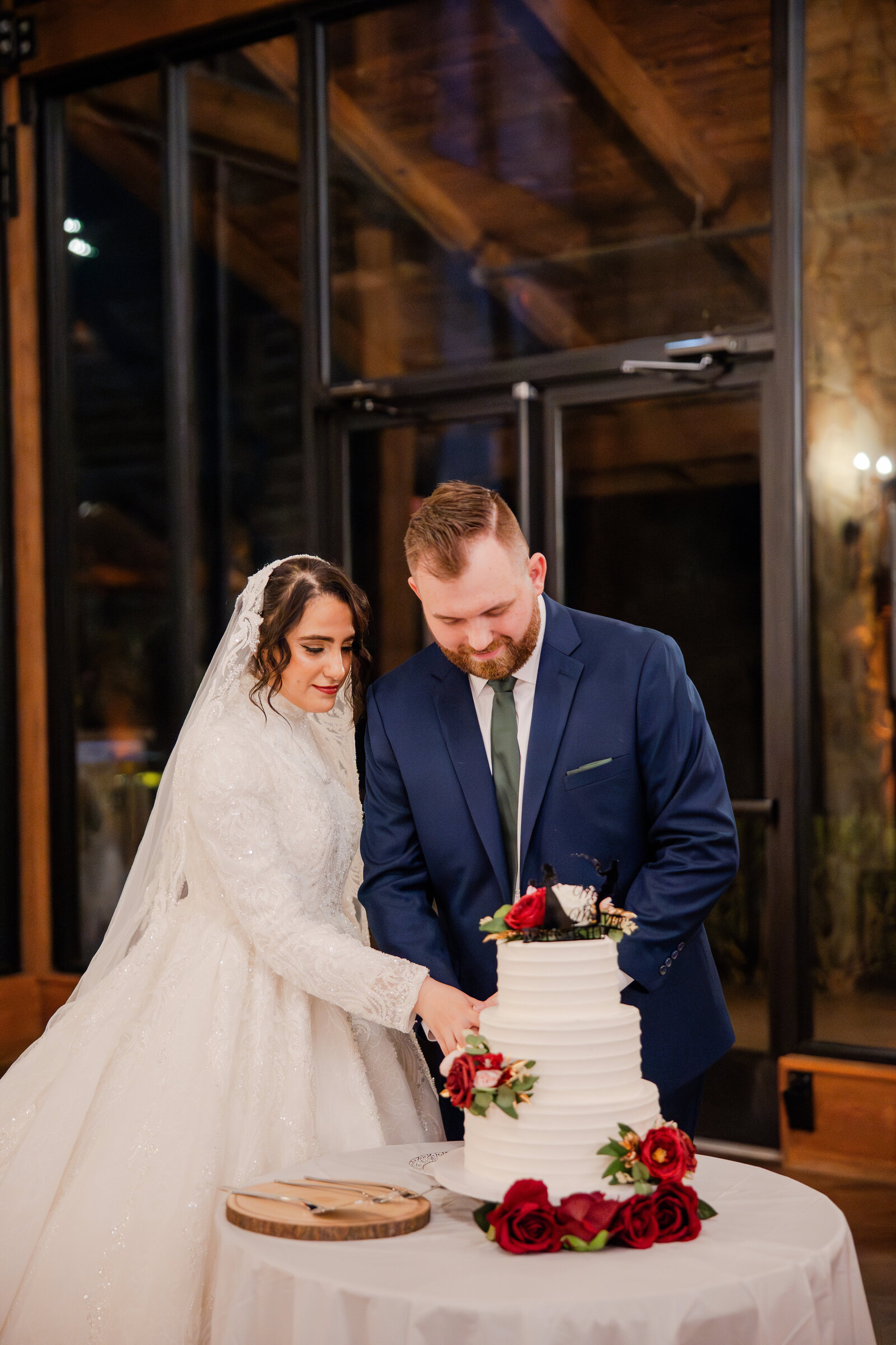 Cake cutting ceremony for couple at wedding reception