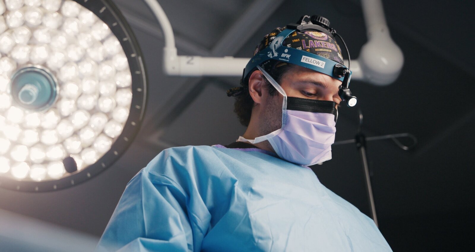 Surgeon in a headlight under an operating room light