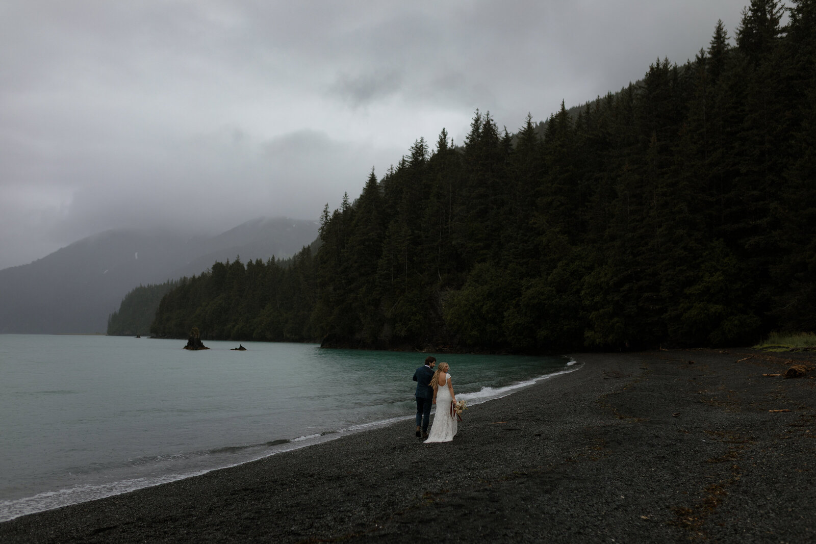 Bride and groom walking in seward alaska